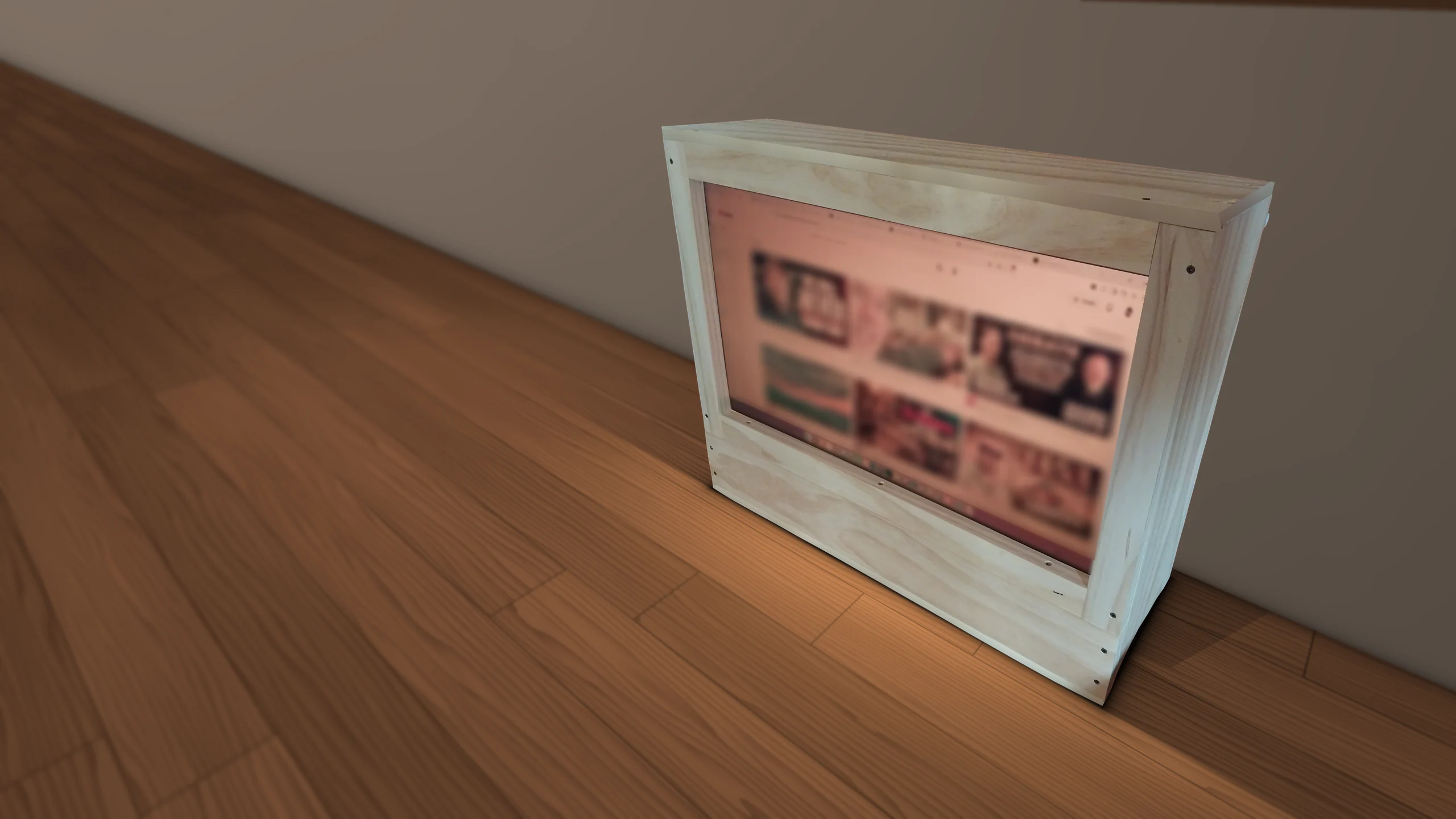 The Firelight on a wooden desk against a wall: a light wooden box with its warm-lit screen set into the front, seen from the front right. The screen's contents are blurred.